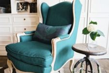 07 a vintage dark green wingback with light-colored wooden framing is a gorgeous statement piece