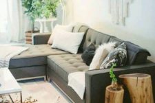 08 a boho chic space with a large grey secctional sofa that makes the base of the room