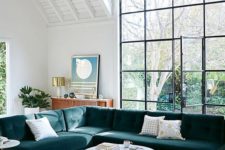 08 a large teal velvet L-shaped sectional sofa is a statement piece in this airy space
