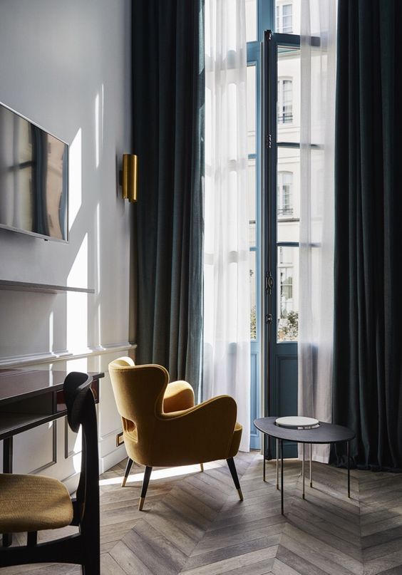 navy velvet curtains add a refined touch to the space and hide the space from sunlight the best way possible