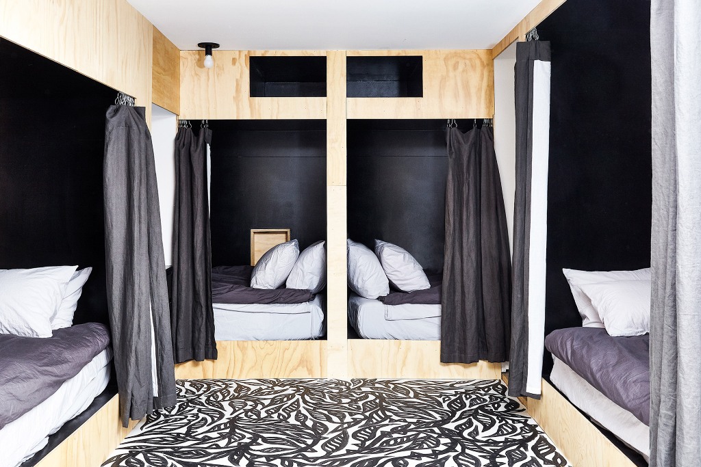 The guest bedroom is done in a creative way, there are four beds with curtains to achieve some privacy