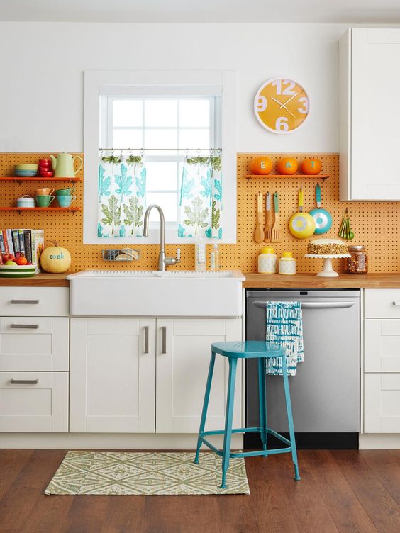 a pegboard backsplash is a creative idea that allows accomodating a lot of things
