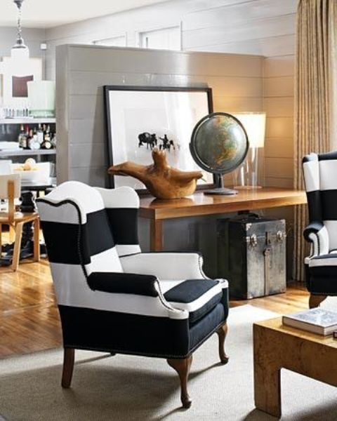 a traditional wingback chair in black and white stripes for a vintage and rustic interior