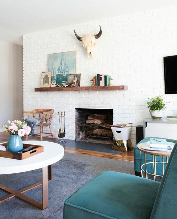 an asymmetrically attached mantel accents the fireplace and the arrangement on it