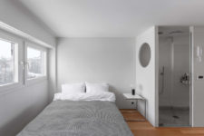 10 The bedroom space is serene and small, with a large bed and a single nightstand