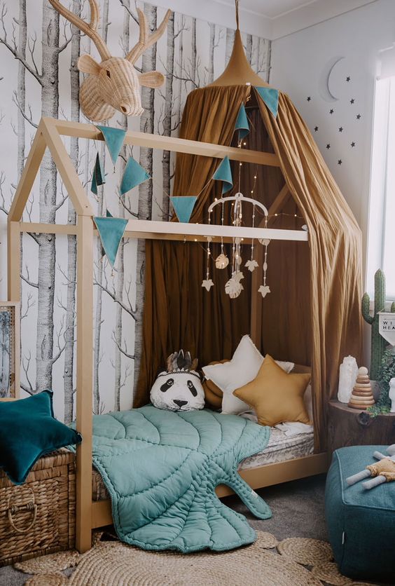 a beautiful forest-inspired kids' room with an unique bed is lively yet not too bright, with a perfect balance