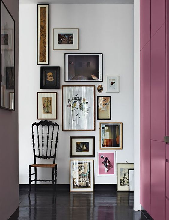 a bold asymmetrical art wall is a great way to accent the space and make it unique