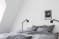 11 a comfy and small Scandinavian attic bedroom with a grey bed and some lamps – nothing else is needed here