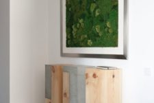 11 a framed moss wall art over an industrial three-piece console is a bold modern idea