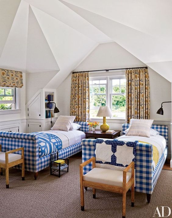 a guest bedroom done with blue and white buffalo check upholstered beds to bring a welcoming feel