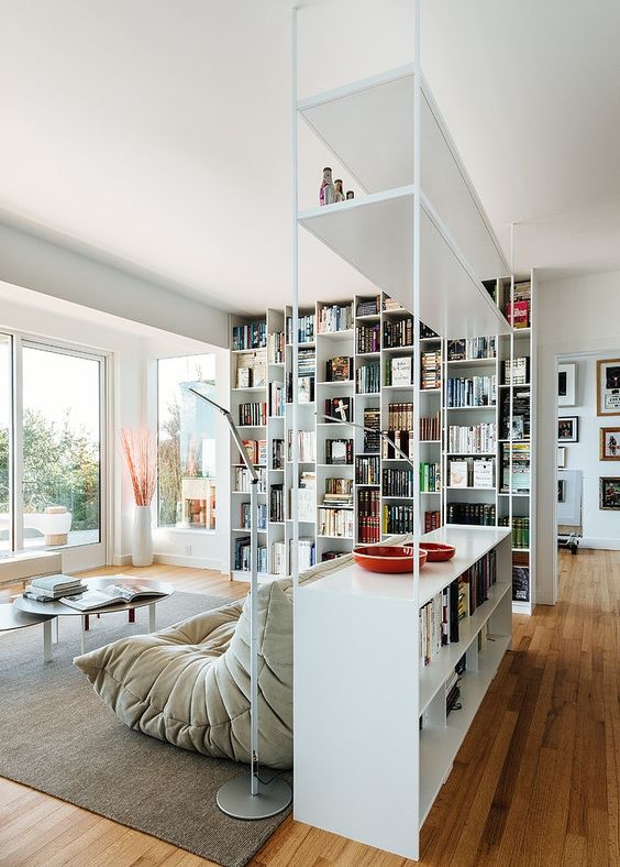 an airy metal shelving unit with open and box shelves looks very contemporary