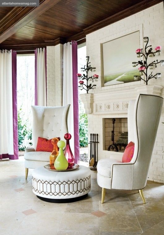 a bold take on a wingback chair with a super tall back and gilded legs for a modern space