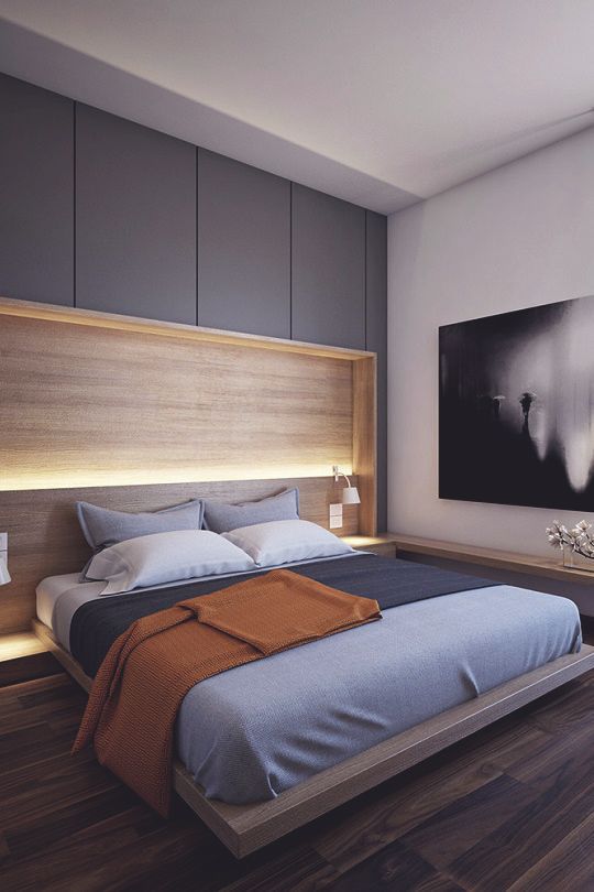 a contemporary bedroom with a floating bed, a lit up headboard and a large artwork