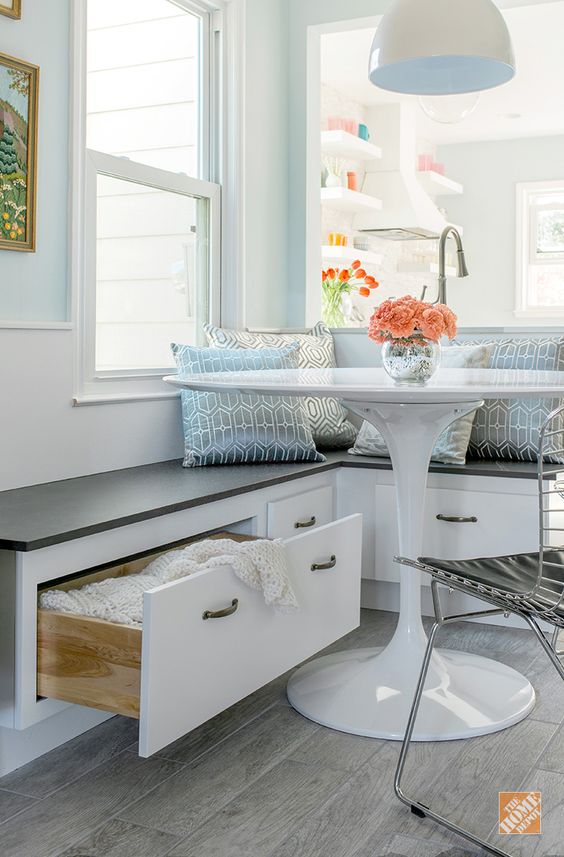 A cozy breakfast nook with a built in corner bench with storage is a perfect solution