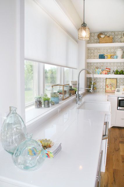 a semi sheer white Roman shade is an ideal solution for a kitchen or a bathroom
