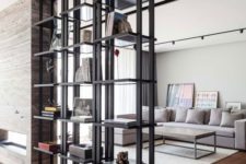 12 black metal open shelving divides a living room and a dining space and looks lightweight