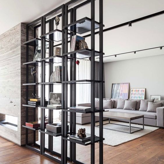 black metal open shelving divides a living room and a dining space and looks lightweight