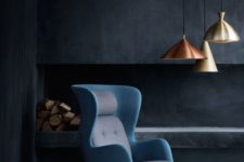 13 a bold wingback chair with a mid-century modern twist in grey and blue is a show-stopper in this moody space