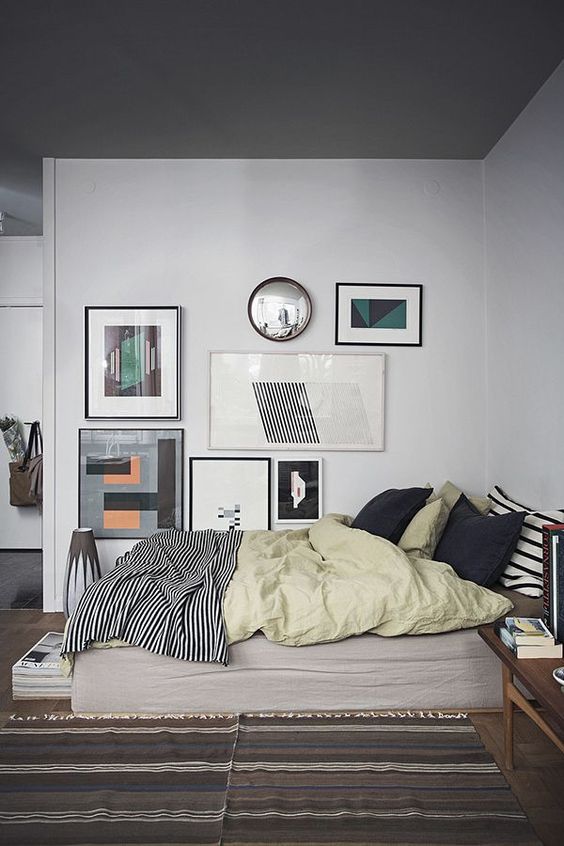 a large and bold asymmetrical gallery wall is a great accent feature for the bedroom
