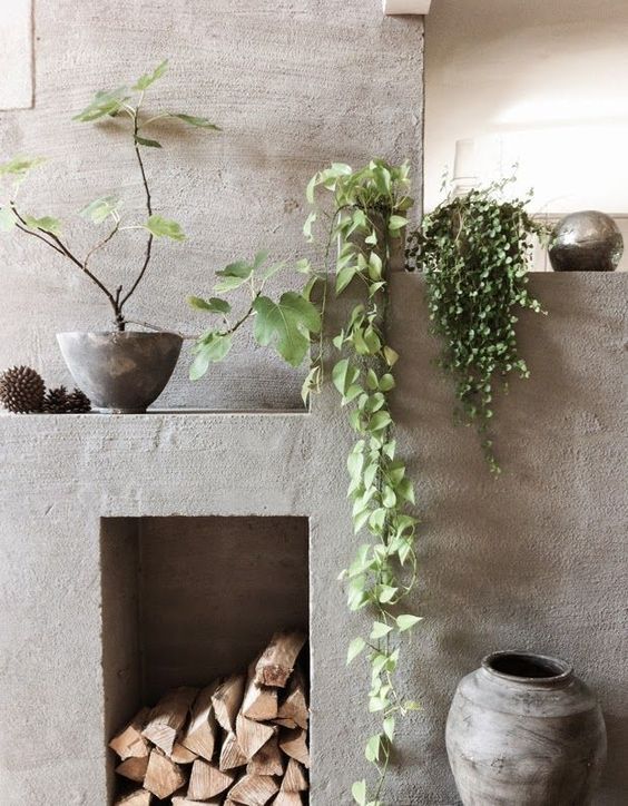 enliven the concrete fireplace with climbing plants hanging from the mantel
