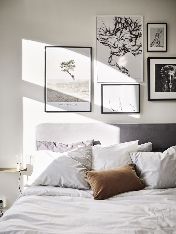 a black and white gallery wall with photos is a great option for a contemporary bedroom