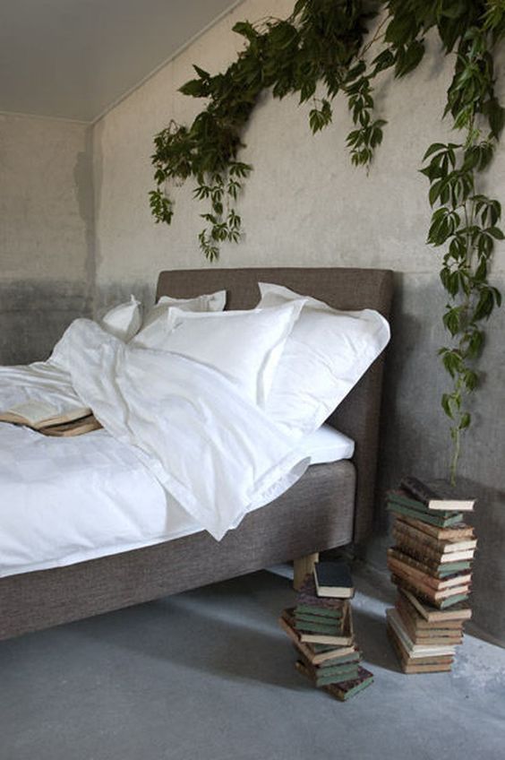 a lush climbing plant over the bed enlivens the space and makes it fresh and bold