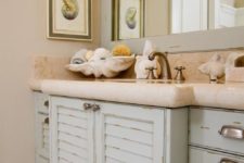14 a sink vanity made of old pastel-colored shutters and a stone countertop for a beach-inspired bathroom
