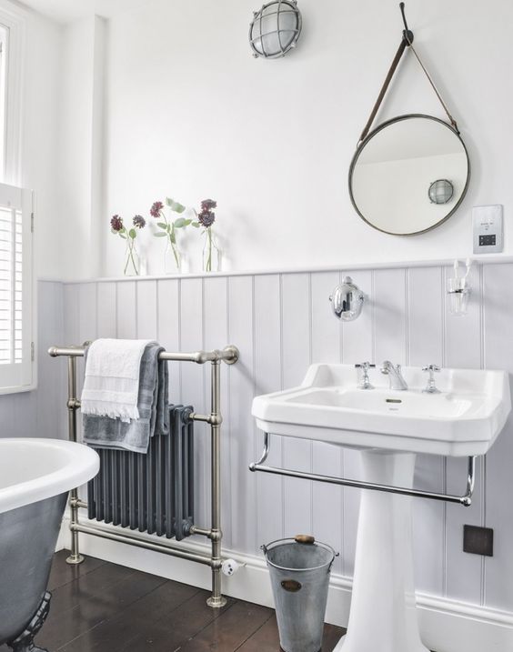 A vintage styled bathroom with lavender colored wainscoting installed rather high