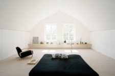 14 an airy minimalist attic bedroom with a bed in the center, a windowsill shelf and a chair