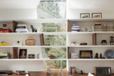 14 an asymmetrical window going up into the skylight and an echoing desk make this home office striking and add character
