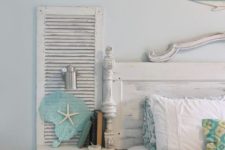 15 a wall-mounted nightstand for a shabby chic beach bedroom is made of an old shutter and a piece of wood