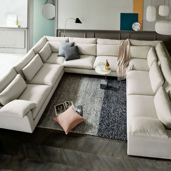 an oversized creamy U-shaped sectional sofa is a great conversation pit base to go for