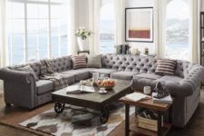 16 a modern farmhouse living room with a grey U-shaped tufted sofa and some rustic tables