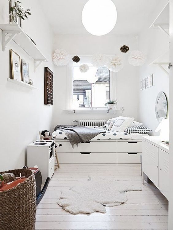 A serene Scandinavian space done with a bed with built in storage drawers is a great idea