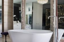 16 a whole mirror wall with an additional vintage mirror and a gorgeous statement chandelier for a refined feel