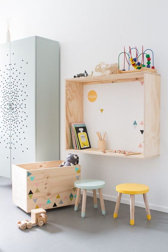 colorful toys, stools and geometric prints on the furniture and wall add a lively touch