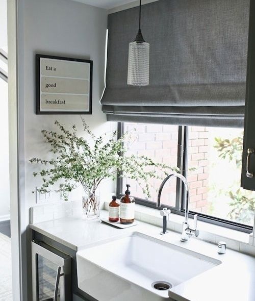 grey Roman curtains are a perfect fit for a Scandinavian kitchen