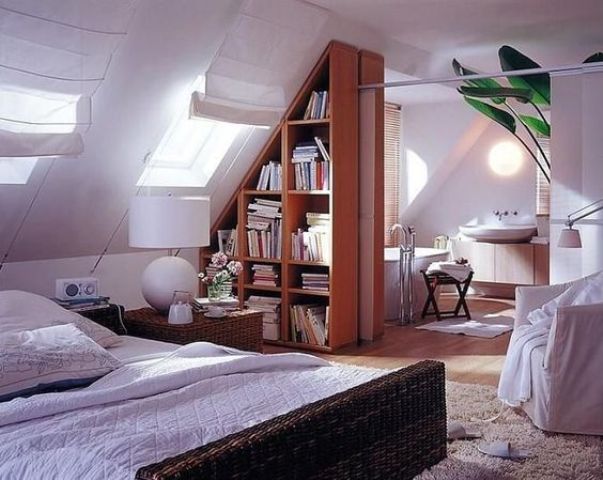 a triangle bookshelf unit is used to separate the attic bedroom and bathroom and make them feel airy