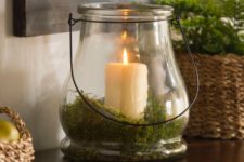 a candle lantern with moss inside is a great idea for spring or summer
