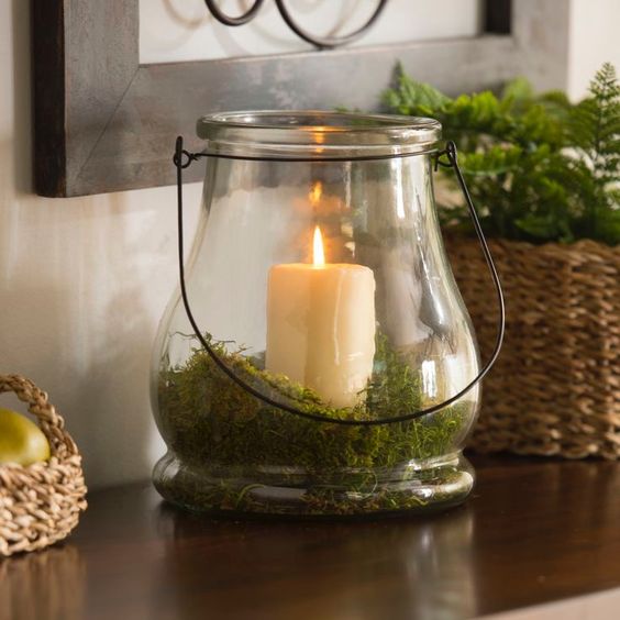 a candle lantern with moss inside is a great idea for spring or summer