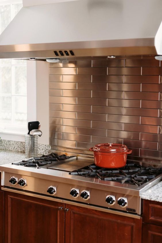 copper colored stainless steel tiles for the cooking zone and a matching cooker for a cool look
