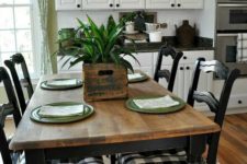 19 vintage black chairs with buffalo check upholstery plus a wooden table and woven lamps create a rustic look
