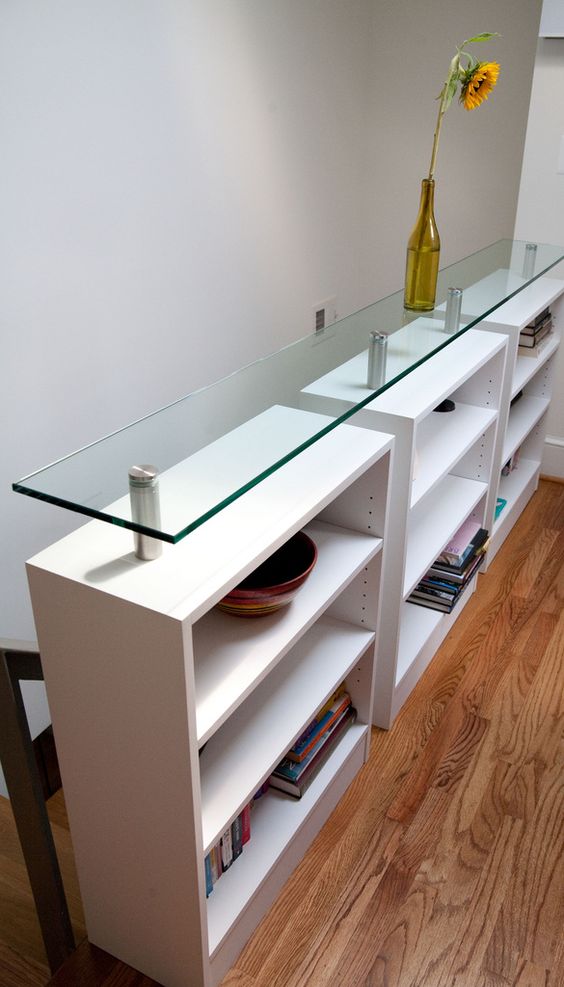 a pony storage wall with a glass top is a great idea to divide the staircase from the rest of the house