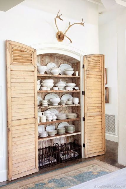 a built-in cupboard with shutters as doors is a sweet and cute idea for a farmhouse kitchen