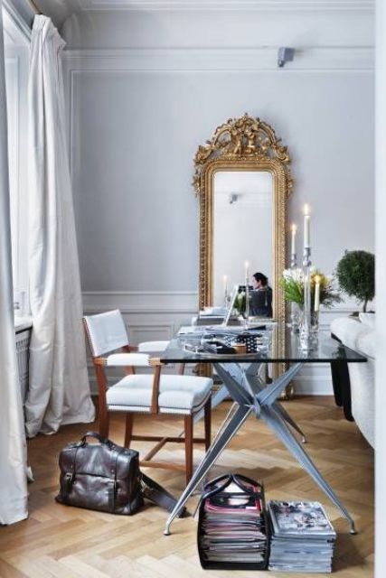 a chic glam home office with a tall narrow mirror in a vintage frame