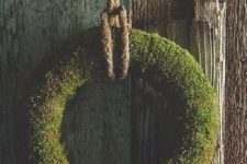 21 a large moss wreath with rope will add a raw rustic touch to the space