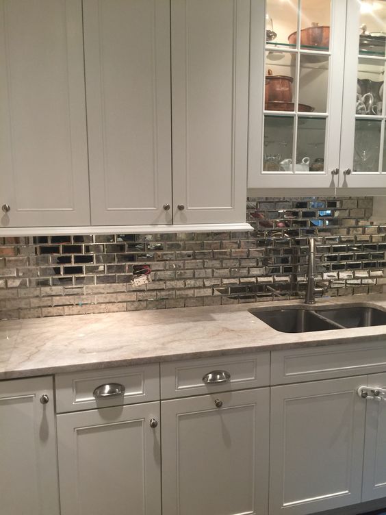 a silver tile backsplash makes this pearly colored kitchen shine on