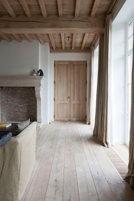 a warm rustic wood ceiling with beams adds eye-catchiness and coziness to the space