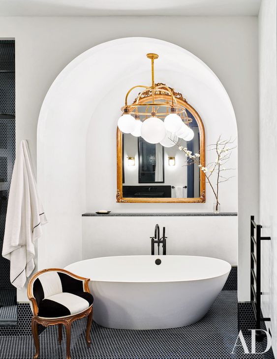 go for a stylish framed mirror in your bathtub niche for an elegant touch
