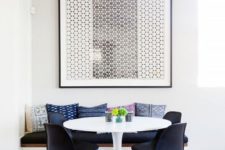 22 a small mid-century modern dining room with a bold graphic artwork that takes over it